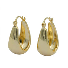 Wide polished gold-tone hinged hoop earrings on white.
