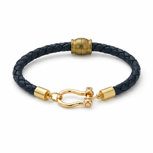 Black braided leather bracelet with gold clasp on a white background