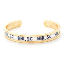 Gold bracelet with 'HHI, SC' text on a white background