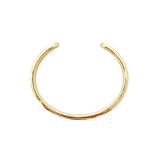 Gold hoop earring on a white background