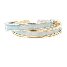 Two bracelets with gold and silver bands on a white background