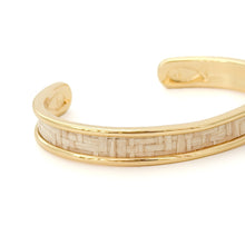 Gold bracelet with a textured band on a white background