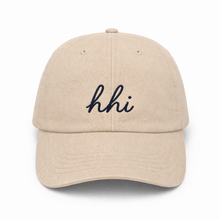 Beige cap with 'hhi' embroidery on a white background