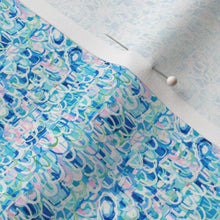 Fabric with a blue and pink abstract pattern on a white background