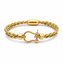 A gold-plated braided cord bracelet with a polished gold-tone buckle clasp, shown on a clean white background.