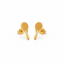 Gold tennis racket-shaped earrings on a white background