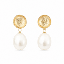 Gold earrings with pearl drops on a white background