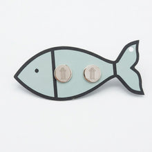 Fish-shaped card with two round earrings on a light gray background