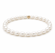 Pearl bracelet with a gold clasp on a white background