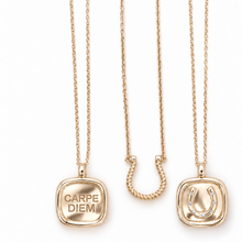Three gold necklaces displayed vertically on a white background: a square pendant engraved with 'CARPE DIEM', a U-shaped pendant with a twisted center, and a square pendant featuring a horseshoe design.