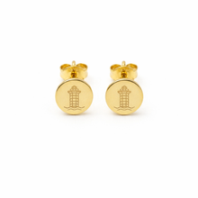 Gold earrings with a harbor town design on a white background