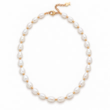 A pearl and gold beaded necklace arranged in a circle on a clean white background. The necklace features lustrous white freshwater-style pearls separated by small gold beads, with a gold clasp and extender chain at the top.