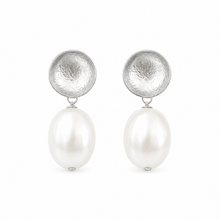 Pair of earrings with silver circular tops and white pearls on a white background