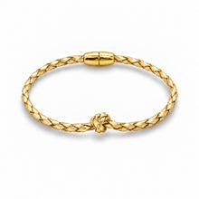 A gold braided cable bracelet with a knotted detail and a smooth cylindrical clasp, shown on a clean white background.