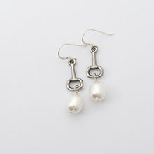 Silver equestrian-themed earrings with pearls on a light gray background