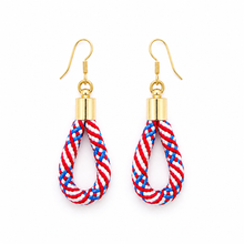 Pair of earrings with red, white, and blue rope design on a gold hook against a white background