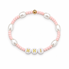 Bracelet with pink, silver, and gold beads spelling 'HI'.