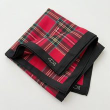 Red plaid fabric with black border on a white background