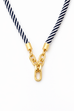 Navy and white striped necklace with gold chain on a white background