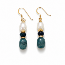 Pair of earrings with pearls and blue stones on a white background