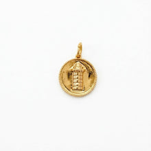 harbor town lighthouse charm 
Gold pendant with intricate design on a white background