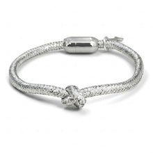 Silver bracelet with a knot design on a white background