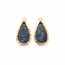 A pair of teardrop-shaped ditsy earrings featuring a textured navy blue fabric center set in a hammered gold-tone bezel with a top loop, shown on a plain white background.
