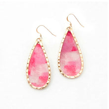 Teardrop-shaped earrings with pink and white watercolor design and gold frames on a white background