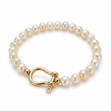 Pearl bracelet with a gold clasp on a white background