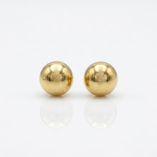 Pair of gold round earrings on a white background
