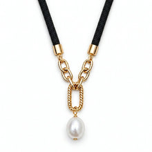 A gold chain necklace featuring a black braided cord, a twisted gold link detail, and a dangling white freshwater pearl, shown on a plain white background.