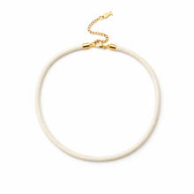 White necklace with gold clasp on a white background