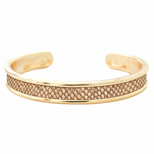 A gold-toned open cuff bracelet featuring a textured pavé band with small clear stones, shown on a plain white background.