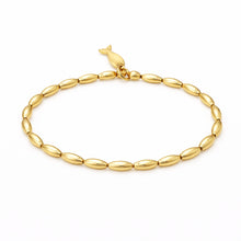 Gold bracelet with a bird clasp on a white background