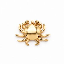 A polished gold crab pendant or charm, centered on a clean white background.