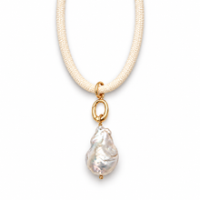 A delicate necklace featuring a textured cream-colored braided cord and a baroque pearl pendant in a gold setting, shown against a plain white background.