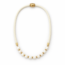 A delicate necklace featuring a cream braided cord, a row of white baroque pearls, and small gold spacer beads, finished with a gold clasp at the top, shown on a plain white background.