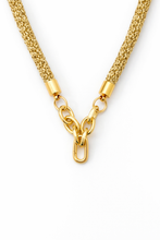 Gold chain necklace on a white background