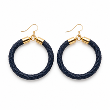 Pair of navy hoop earrings with gold accents on a white background