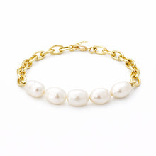 Gold chain bracelet with pearls on a white background