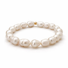 Pearl bracelet with a gold clasp on a white background