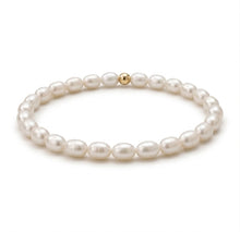 Pearl bracelet with a gold clasp on a white background