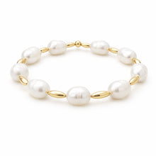 Pearl bracelet with gold accents on a white background