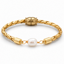 A gold braided cord bracelet featuring a single white baroque pearl and polished gold end caps, shown on a clean white background.