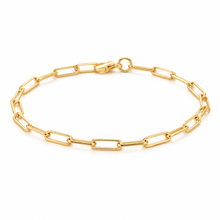 A gold paperclip chain bracelet with a lobster clasp, displayed in a circular shape on a clean white background.