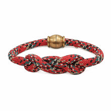 Red and green braided bracelet with a gold clasp on a white background