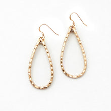 Gold hoop earrings on a white background