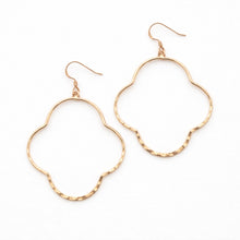 Gold hoop earrings on a white background