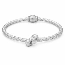 Silver bracelet with a knot design on a white background