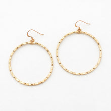 Gold hoop earrings on a white background